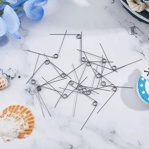 36 Pack 90 Degree V Shaped Torsion Springs, Stainless Steel, 0.5mm Wire Diameter, 5mm Outer Diameter, scattered on surface