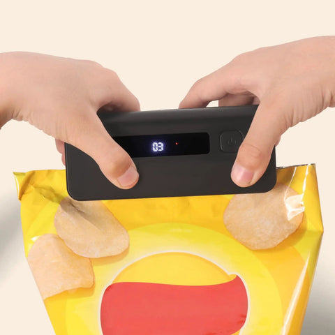 Two In One Mini Bag Sealer With 4.7 Inch Heat Sealer For Potato Chip Bags resealing a snack bag, hands operating the sealer