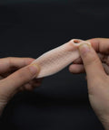Close-up of hands holding Pinky Toe Protector And Bunion Corrector Gel Separator Cushion Sleeve showing texture, part of set of 10.