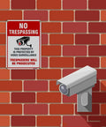 4-Pack No Trespassing Signs Outdoor For Private Property Made From Aluminum 10x14 Inches With UV Ink Print on brick wall with CCTV camera