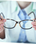 Person holding eyeglasses with 96 Piece Eyeglass Nose Pads Adhesive Cushions For Glasses Nonslip Comfort applied on the bridge.