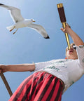 Pirate Monocular Telescope with Treasure Map Pocket Compass Collapsible Spyglass for Party Favors Treasure Hunts Camping Bird Watching and Kid Friendly Adventures Perfect Gift for Young Explorers boy using brass spyglass to watch seagull
