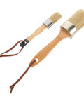 Two-Piece Wood Handle Paint Brush Set for Walls and Decks with oval synthetic bristles, shown at an angle on a white background.