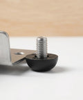 Close-up of a Heavy Duty M8 Adjustable Furniture Leveling Foot with screw-in leg next to a metal bracket