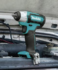 12V Max CXT Impact Wrench 3/8 Inch Drive on engine, ultra compact at 6-3/8 inches, weighs just 2.3 lbs, one-handed tool