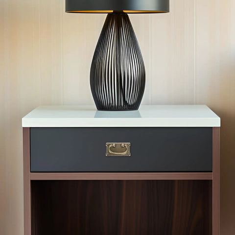 Modern lamp on wooden nightstand with sleek drawer