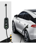 Hassle Free Portable Ev Charger With Type One And Type Two Plugs For Any Electric Ride Heavy Duty Ip67 Weatherproof Cable Built To Take A Beating Smart 16 Amp Charging Station connected to a parked electric vehicle.