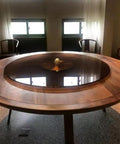 Black Tempered Glass Lazy Susan Turntable Serving Tray, 28 Inch Round Base with Heavy Duty Swivel Mechanism on a dining table.