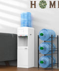 Heavy Duty Steel Water Jug Holder Stand For 5 Gallon Bottles, 3 Tier Water Bottle Organizer in home setting next to dispenser.
