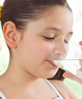 Child drinking water representing the benefits of PH Balancing Ceramic Post Filter For Your RO Setup With One Quarter Inch Quick Connect
