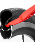 Close-up of Three Pack Bicycle Tire Levers For Road And Mountain Bikes Heavy Duty Self Lubricating Plastic Rim Safe Levers in use