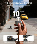 Hand holding Fun Shot Magnetic Phone Grip Turns Your Smartphone Into a DSLR Style Shooter with detachable wireless shutter button.