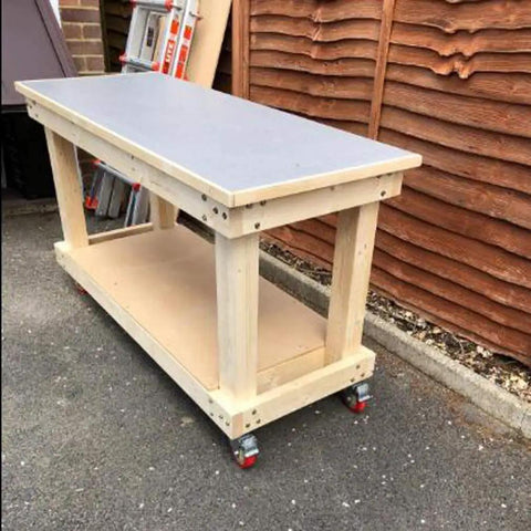 Heavy Duty Swivel Furniture Casters Four Piece Set Five Inch Polyurethane Treads on a mobile workbench with wooden base.