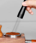 Hand using Espresso Coffee Stirrer Tamper And Needle Type WDT Distribution Tool on coffee grounds in portafilter, 5.9 Inch, 304 stainless steel