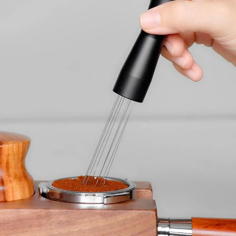 Hand using Espresso Coffee Stirrer Tamper And Needle Type WDT Distribution Tool on coffee grounds in portafilter, 5.9 Inch, 304 stainless steel