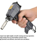 Hand holding lightweight pneumatic nail gun for trim and finish work, pin nailer for woodwork, air nail gun with durable metal build.