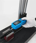 Slick Handheld Digital Surface Roughness Tester Portable Profilometer measuring Ra and Rz on a black workbench.