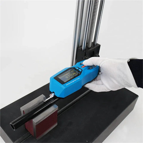 Slick Handheld Digital Surface Roughness Tester Portable Profilometer measuring Ra and Rz on a black workbench.