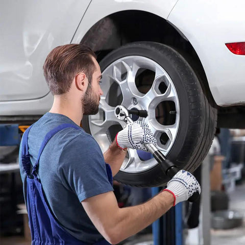 Mechanic using Half Inch Drive Click Torque Wrench Dual Direction Adjustable, 10-150 Ft-Lb on a car wheel.