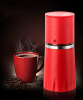 Kickstart Your Morning Anywhere With This Portable Manual Coffee Maker Equipped With Integrated Grinder And Bean Compartment Ideal For Camping Runs And Highway Hauls Pull Smooth Rich Brews Straight To Mug Effortless. Red manual coffee maker beside a steaming mug of coffee.