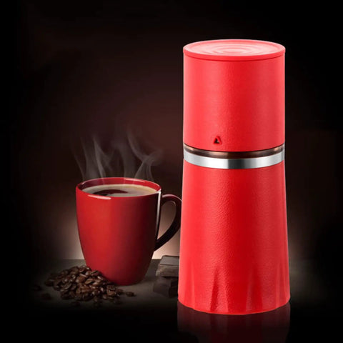 Kickstart Your Morning Anywhere With This Portable Manual Coffee Maker Equipped With Integrated Grinder And Bean Compartment Ideal For Camping Runs And Highway Hauls Pull Smooth Rich Brews Straight To Mug Effortless. Red manual coffee maker beside a steaming mug of coffee.