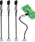 Front view: four black magnetic soldering helping hands with silver clamp heads and round bases; PCB on right.