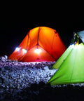 Night camping scene with two tents illuminated by Three Pack Portable LED Camping Lights With Three Modes High Low And Strobe Lightweight ABS Bulbs