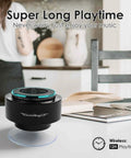 Compact black Bluetooth speaker on white table in home setting with text about 12-hour wireless playtime