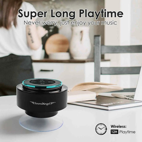 Compact black Bluetooth speaker on white table in home setting with text about 12-hour wireless playtime