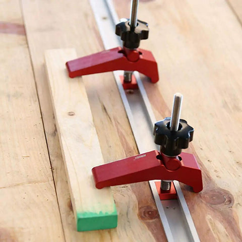 Rock Solid Aluminum T Track Hold Down Clamps For Woodworking And Metalworking Projects Plus Quick Slide In T Slot Press Clamps securing a wooden workpiece.