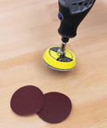 100 Pack 2 Inch Sanding Discs Kit With Polishing Pad Plate, Assorted Grits 40 Through 400, on wood surface with rotary tool.