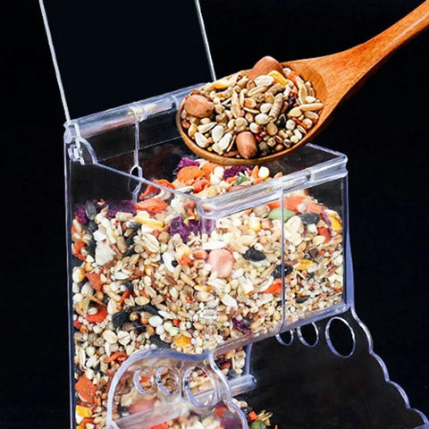 Clear Acrylic Automatic Pet Food Dispenser 300ml For Small Animals And Birds showing filled hopper with mixed seeds and nuts.
