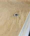 Close-up of a square-drive 316 marine-grade stainless steel deck screw head embedded in plywood.