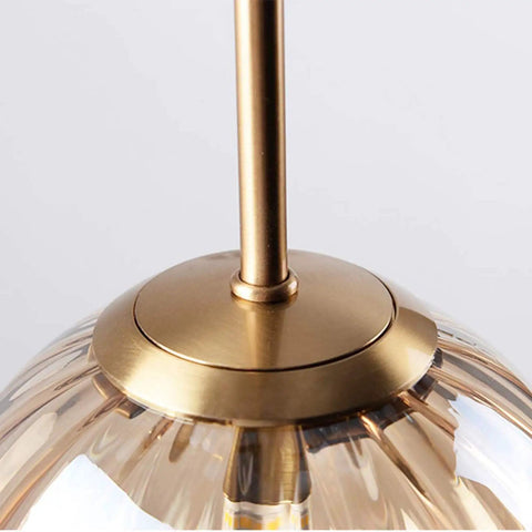 Close-up of gold-tone fixture on Three Light Globe Amber Glass Pendant Lighting With E14 Socket Glass Hanging Lamp Chandelier.