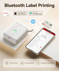 D110 Bluetooth Label Maker With Thermal Printer next to smartphone showing app, included tape, compact design for home office.