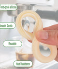Silicone Steam Ring 54mm Gasket Replacement For Espresso Machines Easy Install Two Pack held in hand near espresso machine.