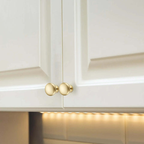 Top Shelf Solid Cabinet and Drawer Knob Sets with Kickass Brushed Gold Finish Crafted from Heavy Duty Zinc Alloy for Built Tough Kitchen and Bath Remodel Upgrades on white cabinets.