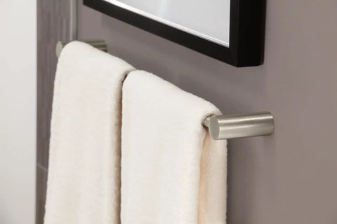 Align 24-Inch Modern Single Towel Bar In Brushed Nickel, wall-mounted with white towels in bathroom.
