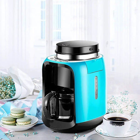 Hassle Free Mini Coffee Maker With Built In Bean Grinder And Glass Carafe, Solid Six Cup Drip Brewer in bright blue color.