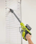 18V Brushless Cordless Compact Stick Vacuum Cleaner bare tool cleaning window blinds with extension wand.