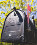 Mailbox Latch Replacement Kit For Group Standard And Post Mailboxes shown on a black metal mailbox with red flag