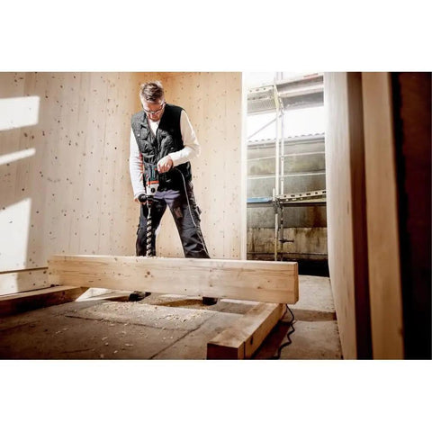 Man using Beast 1300W Hammer Drill With Impulse Mode For Damaged Screw Removal And Spot Drilling in construction site