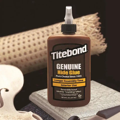 Top Tier Liquid Hide Glue For Fine Woodworking And Furniture Restoration Quick Setting Reversible Adhesive 8 Ounce Bottle shown on wood surface.