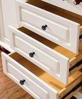 Black Cabinet Knobs, 6 Pack, 1-1/4 Inch Round Single Hole Drawer Knobs For Dresser And Kitchen Cabinets installed on white drawers