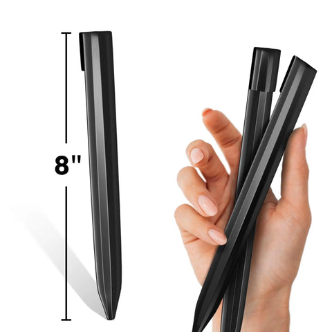 Hand holding 8-Inch black corrugated Landscape Edging Stakes Set, 13 Piece, for garden borders and anchoring support.