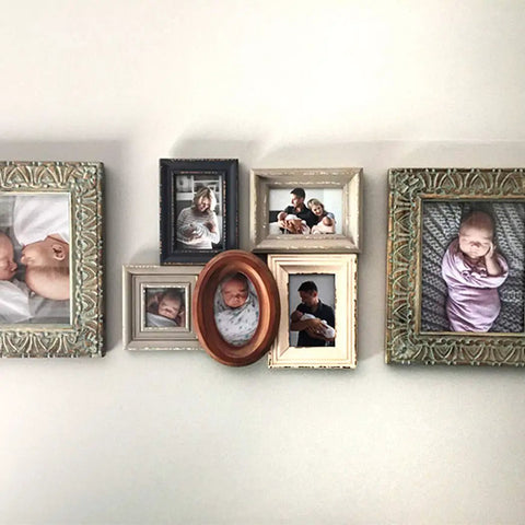Decorative wall with family photo frames hung using Picture Hanger Value Pack Easy Tool Free Drywall Hangers For Artwork Photos And Mirrors Holds Up To 20 To 40 Lbs Per Hook 8 Pack Steel Silver No Tools Needed For Quick And Clean Wall Displays.