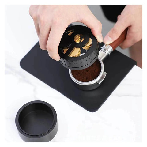 Total Game Changer 58mm Coffee Distributor Needle Tool For Portafilter Leveling, solid aluminum, black finish, in use prepping coffee.