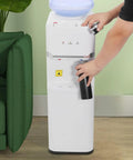 Person using Top Loading Water Cooler For 5 Gallon Bottles With Hot Cold And Warm Water Three Temperature Options And Child Safety Lock