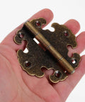 Old School Vintage Zinc Alloy Cabinet Door Hinges 2 Pack in hand, showing retro metal design for wooden wardrobes and furniture.