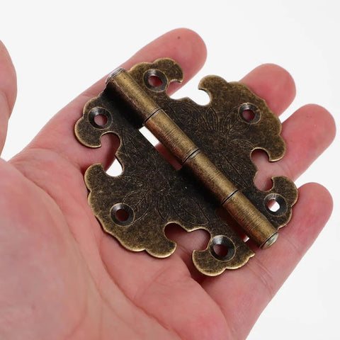 Old School Vintage Zinc Alloy Cabinet Door Hinges 2 Pack in hand, showing retro metal design for wooden wardrobes and furniture.